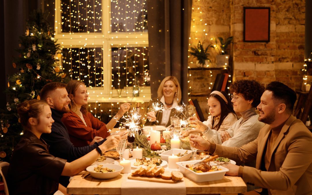 A scene of a family and guest gathered around a table, enjoying Christmas dinner